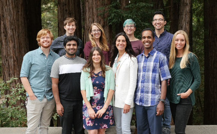 Students studying science journalism at University of California Santa Cruz pose in front of trees