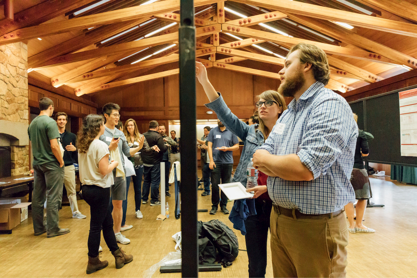 Researchers discussing scientific posters at the CZI Human Cell Atlas Retreat in Asilomar.