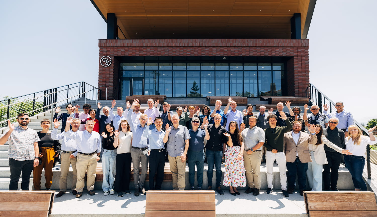 A group of participants at the CZ Imaging Institute Hardware Frontiers for Cryo-ET Workshop stand side by side outside the CZI HQ building.